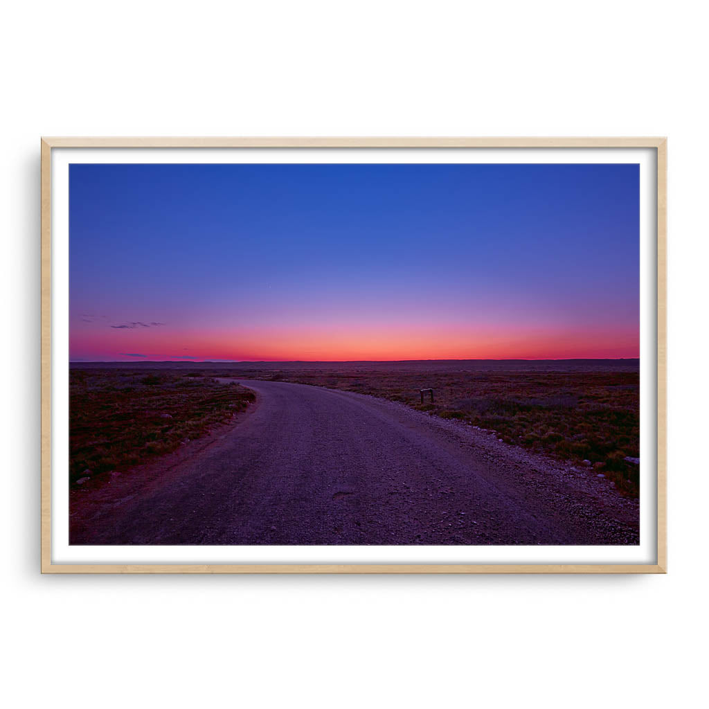 Sunrise over the Cape Range in Western Australia framed in raw oak