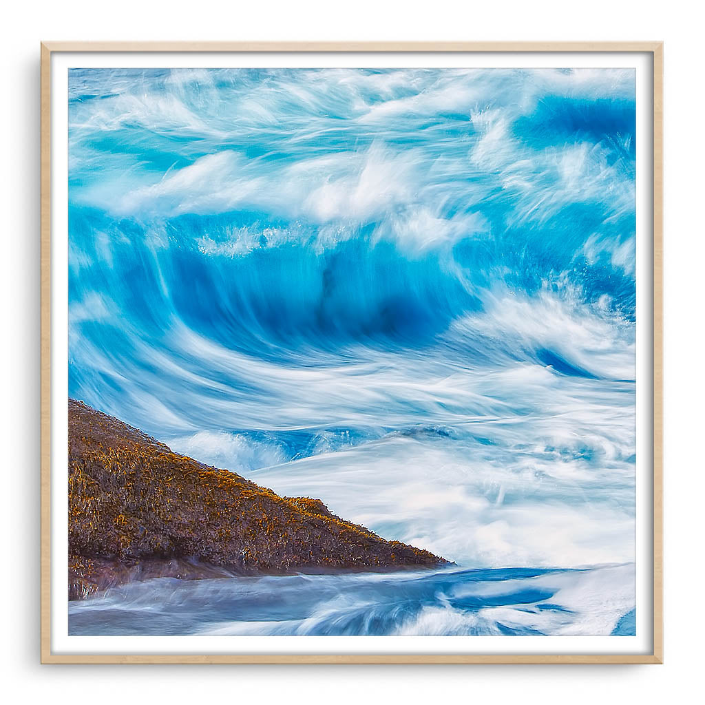 Long exposure of blue wave framed in raw oak