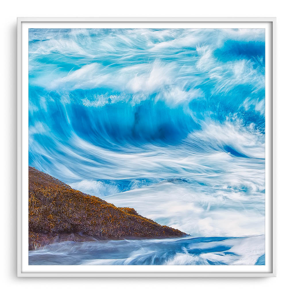 Long exposure of blue wave framed in white