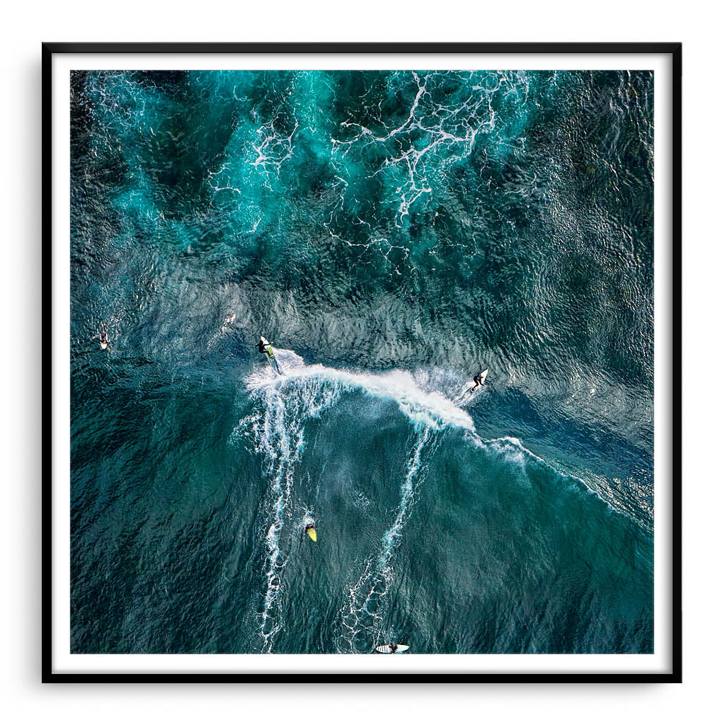 Aerial view of two surfers at Margaret River Main Break in Western Australia framed in black