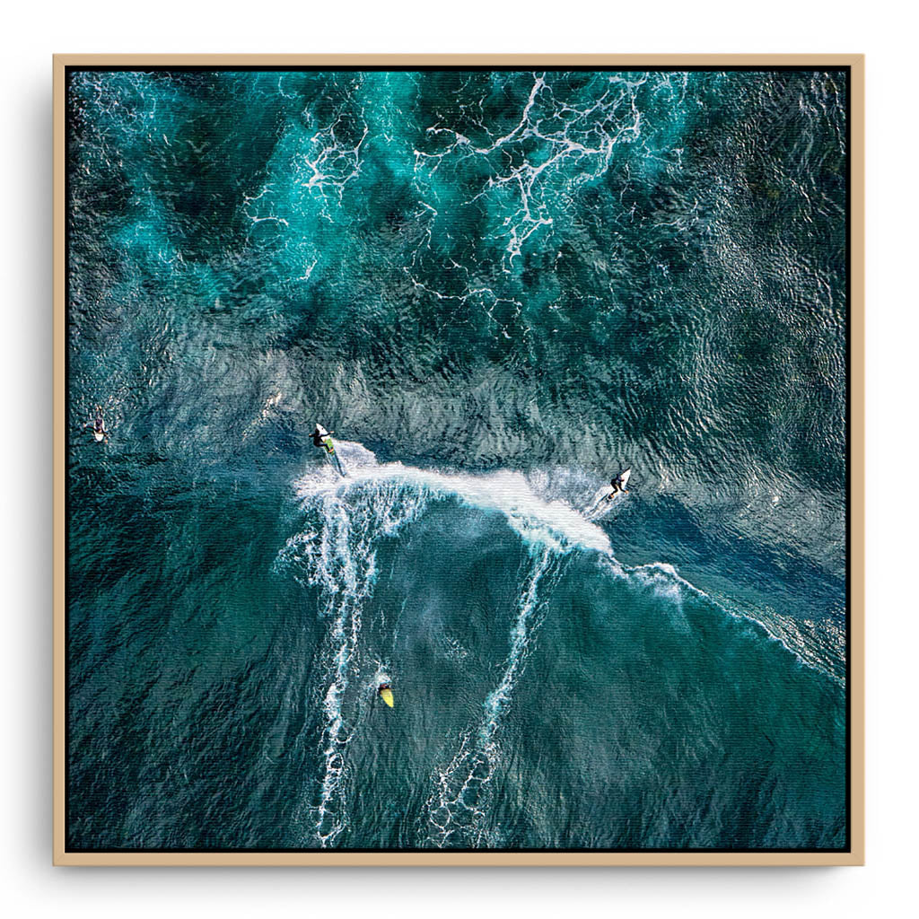 Aerial view of two surfers at Margaret River Main Break in Western Australia framed canvas in raw oak