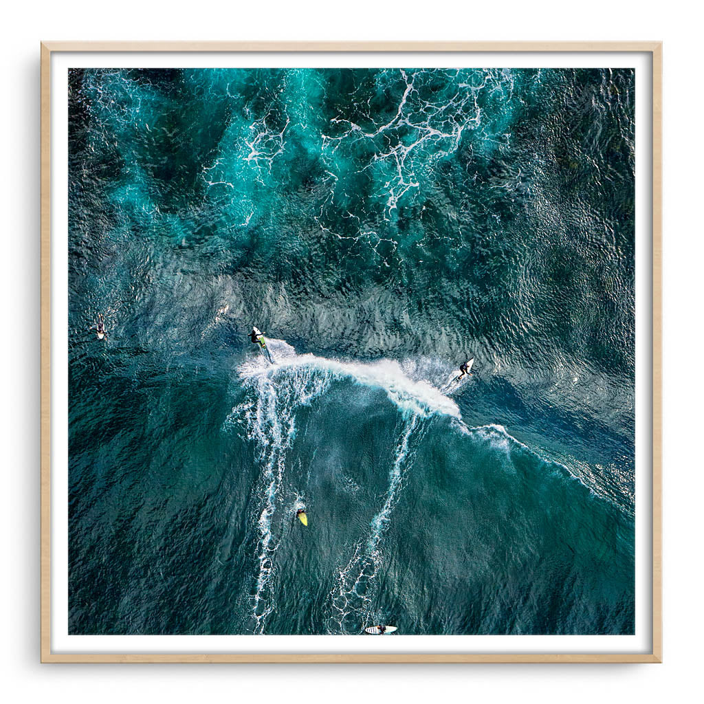 Aerial view of two surfers at Margaret River Main Break in Western Australia framed in raw oak