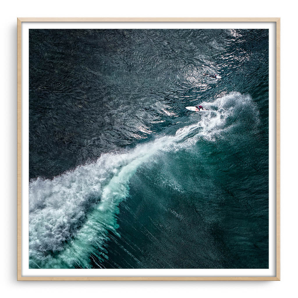 Aerial view of surfer at Margaret River Main Break in Western Australia framed in raw oak