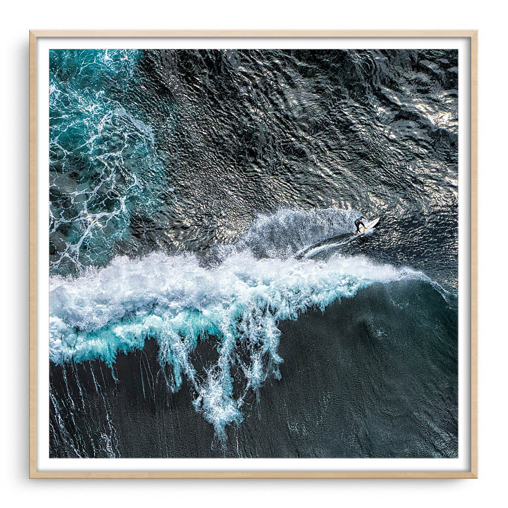 Aerial view of surfer at Margaret River Main Break in Western Australia framed in raw oak