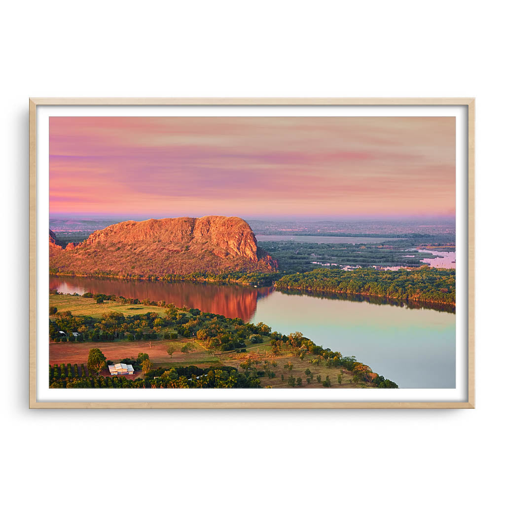Elephant rock at sunset on Lake Kununurra in Western Australia framed in raw oak