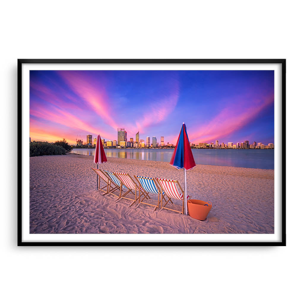 Deckchairs on the beach, overlooking Perth City at sunset in Western Australia framed in black