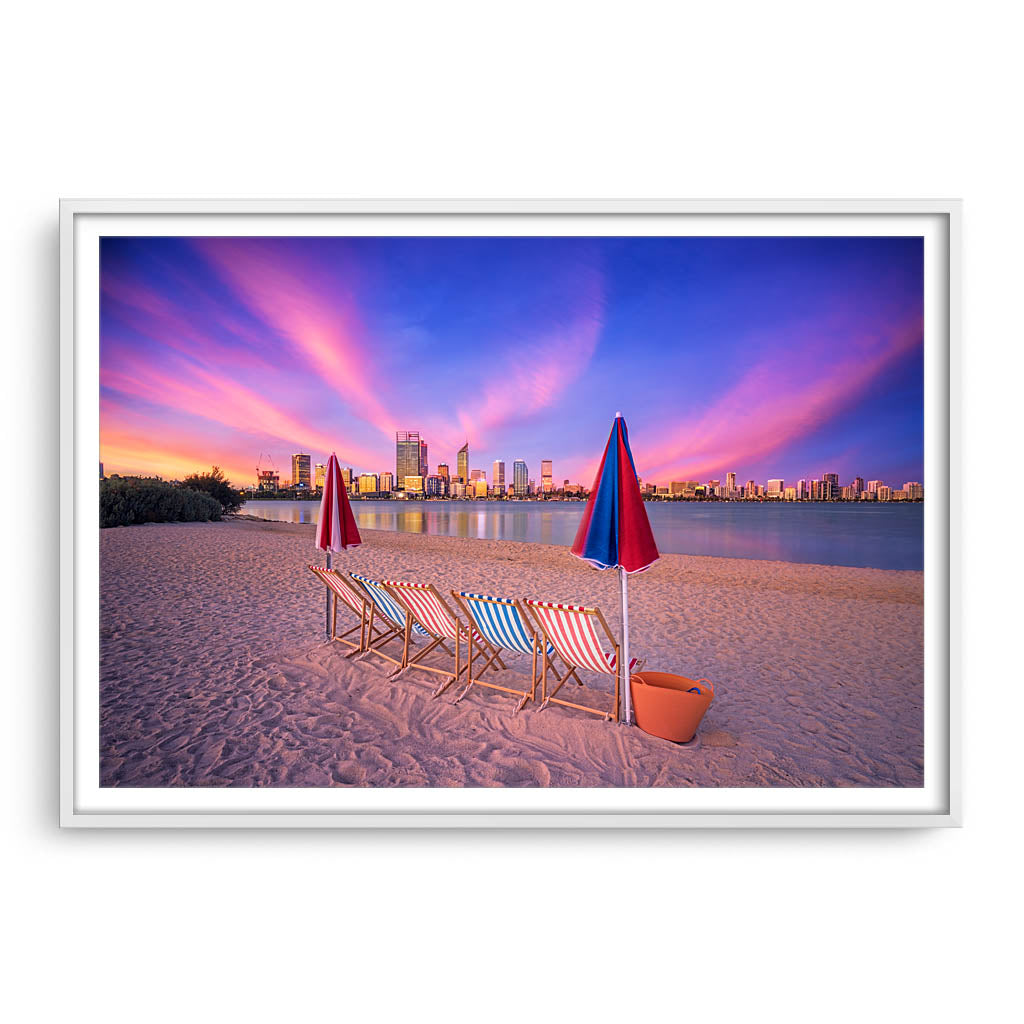 Deckchairs on the beach, overlooking Perth City at sunset in Western Australia framed in white