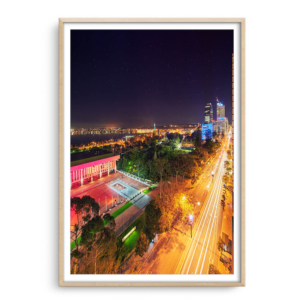 Nighttime down St Georges Terrace in Perth, Western Australia framed in raw oak