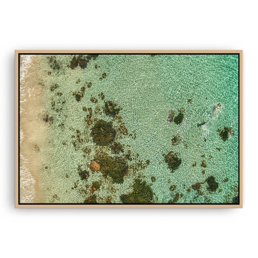 swimming at castle rock in south west australia framed canvas in raw oak