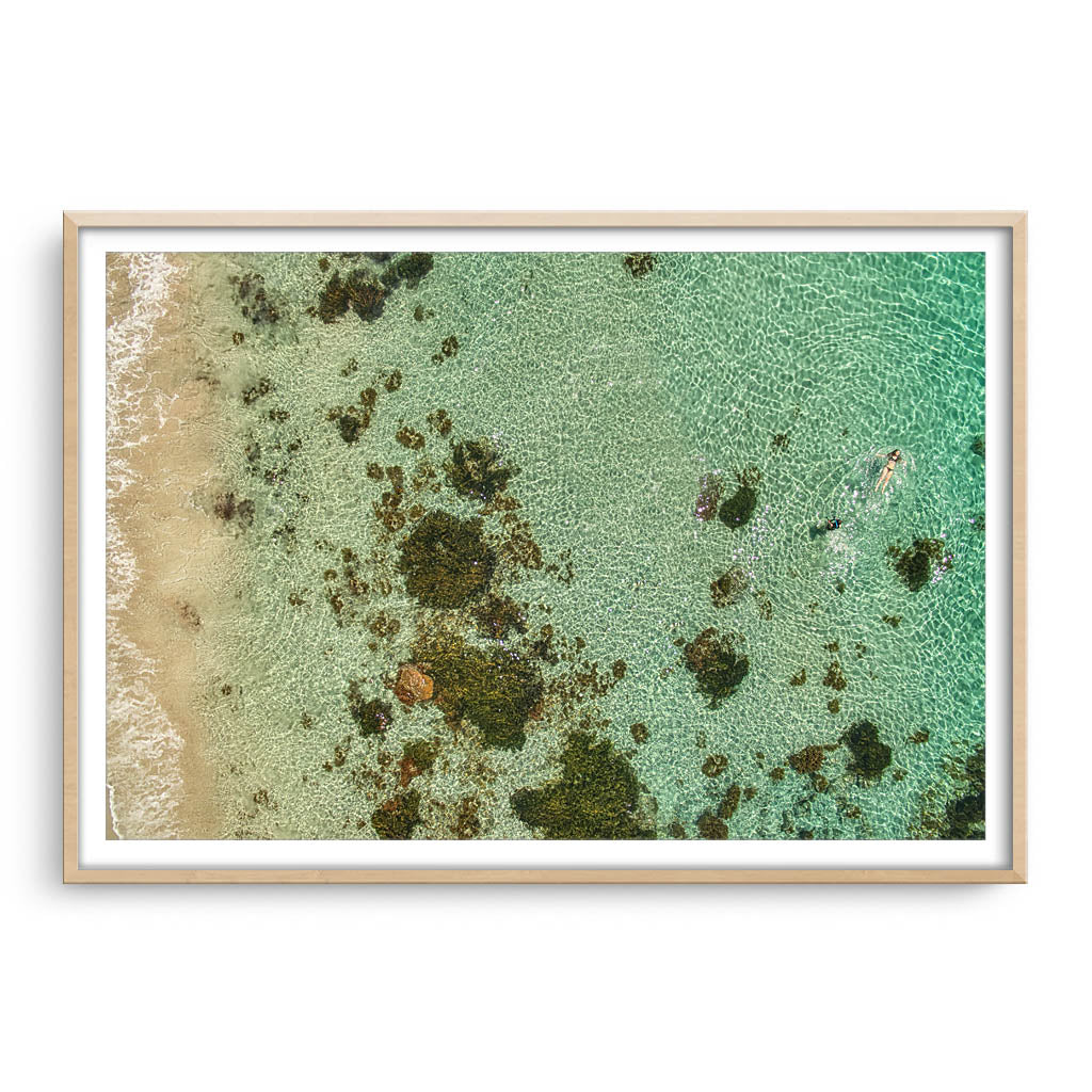 swimming at castle rock in south west australia framed in raw oak