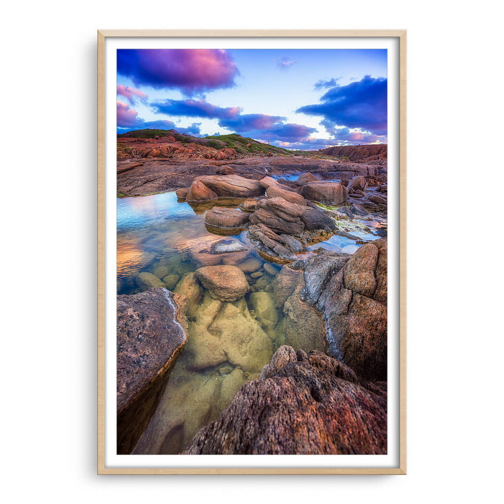 Colourful rock pools at Cape Leeuwin in Western Australia framed in raw oak