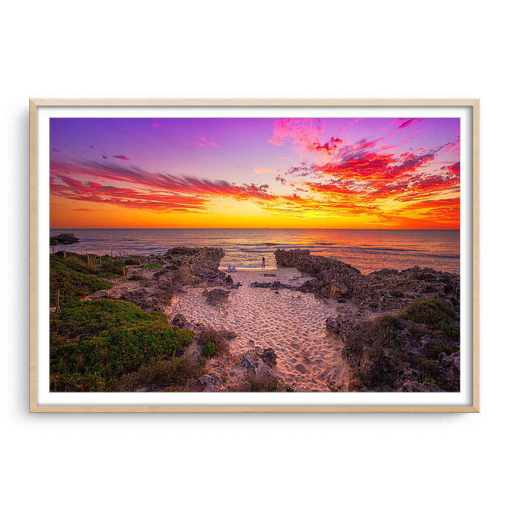 Watching the sunset at Mettams Beach in Western Australia framed in raw oak