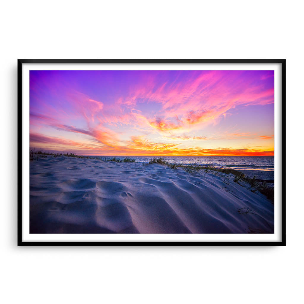 Sunset over the sand dunes at Mullaloo Beach in Western Australia framed in black