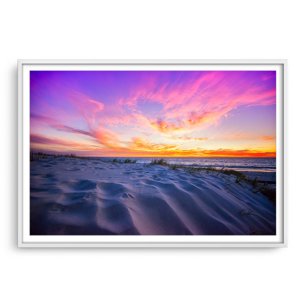Sunset over the sand dunes at Mullaloo Beach in Western Australia framed in white