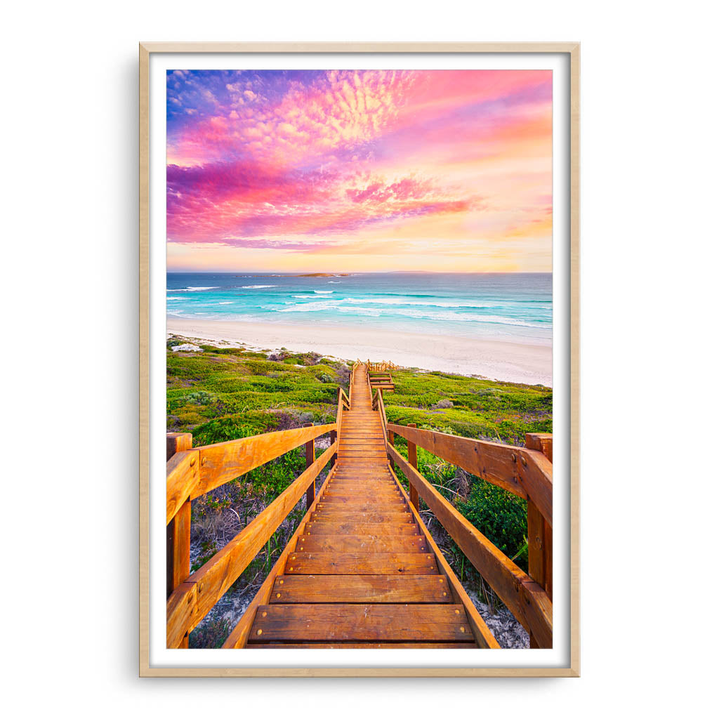 Wooden steps leading down to the beach at sunset in Esperance, Western Australia framed in raw oak