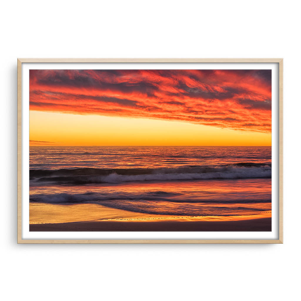 Rich sunset from North Beach in Perth, Western Australia framed in raw oak