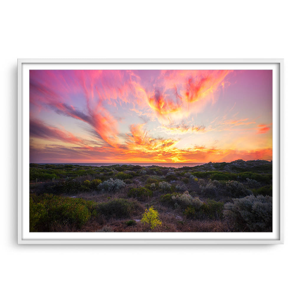 Warm, magenta sunset at Mullaloo Beach in Perth, Western Australia framed in white