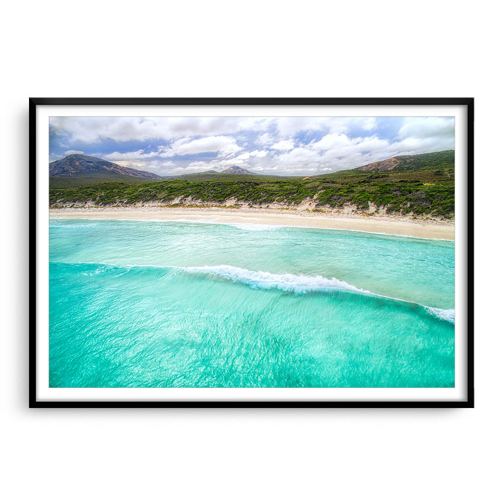 Aerial view of wave rolling into the beach at Hellfire Bay, Western Australia framed in black