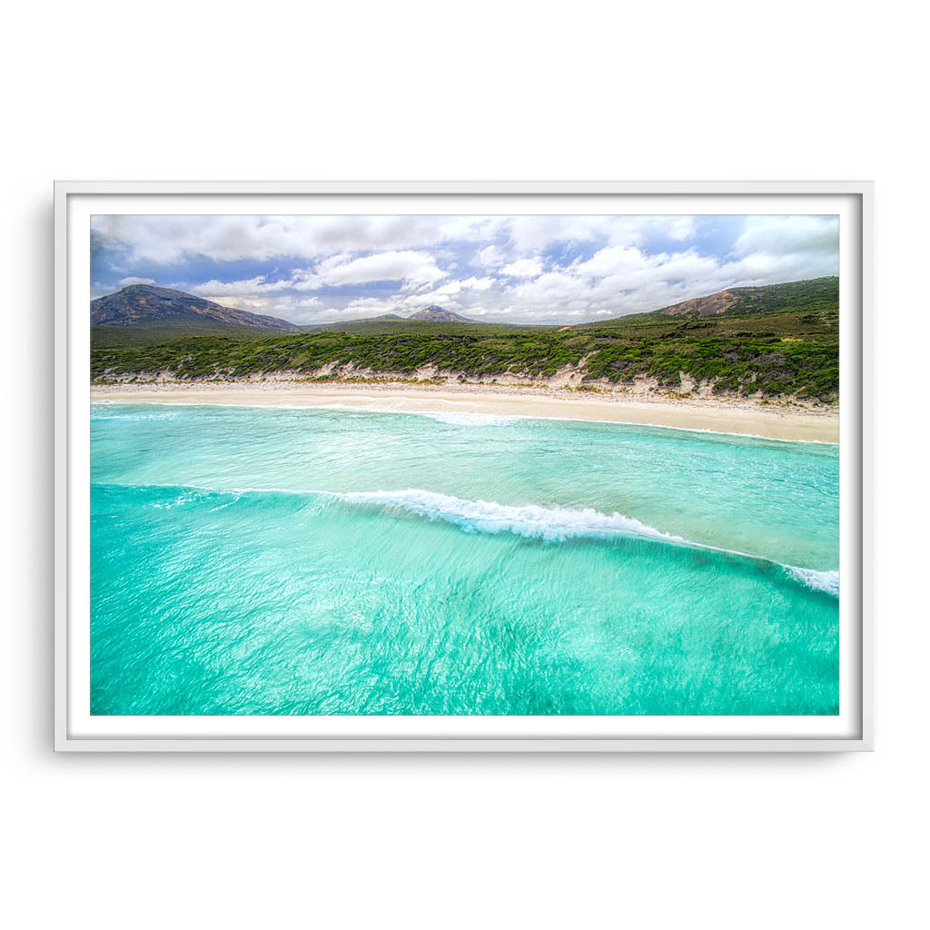 Aerial view of wave rolling into the beach at Hellfire Bay, Western Australia framed in white
