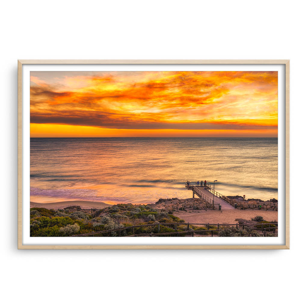 Smoke filled sunset over North Beach Jetty in Perth, Western Australia framed in raw oak