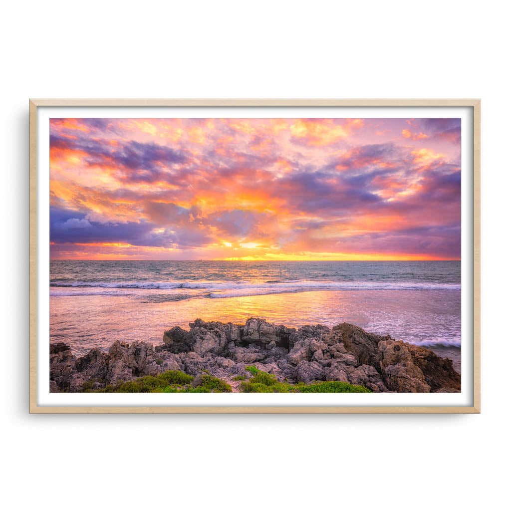 Colourful sunset at Mettams Pool in Perth, Western Australia framed in raw oak