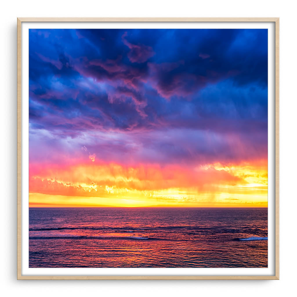 Colourful skies after a thunder storm in Perth, Western Australia framed in raw oak