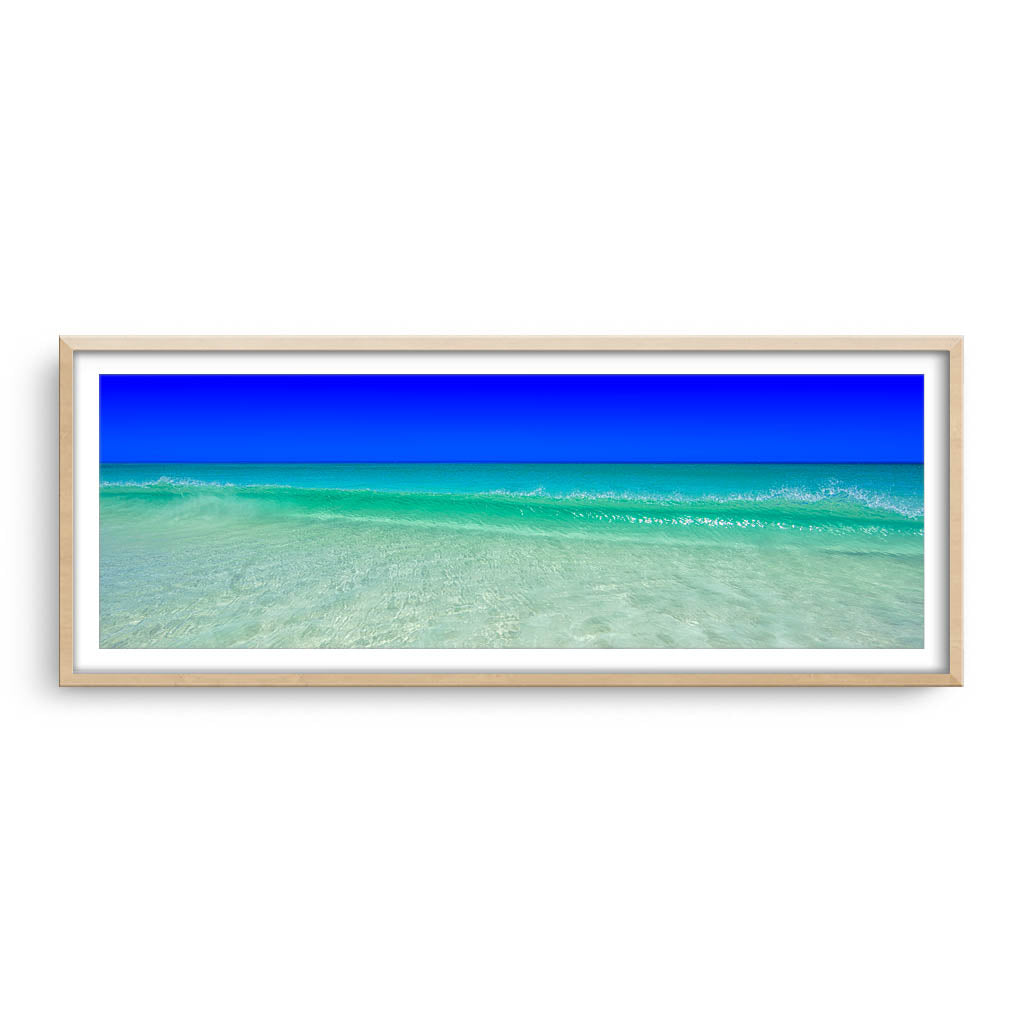 Wave rolling into the shore at Mullaloo Beach in Perth, Western Australia framed in raw oak
