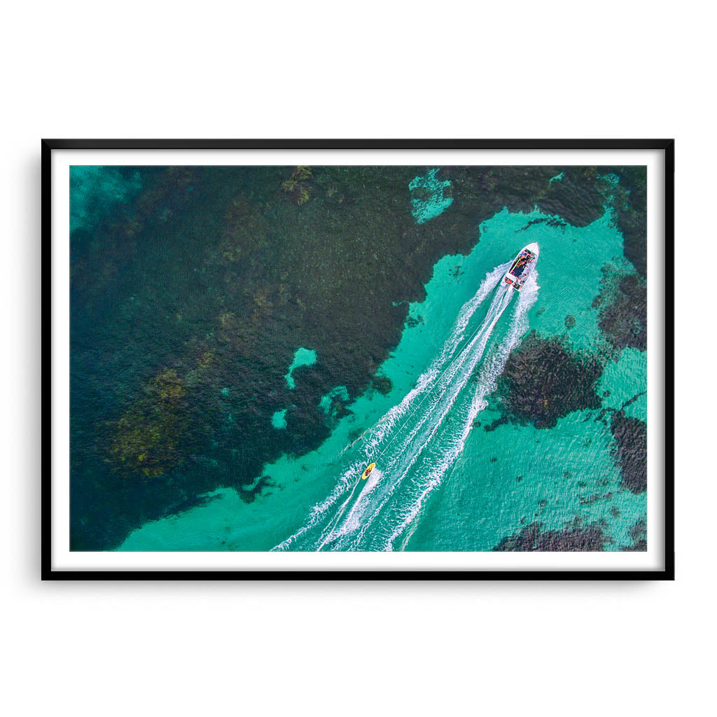 Aerial view of water skier in Augusta, Western Australia framed in black