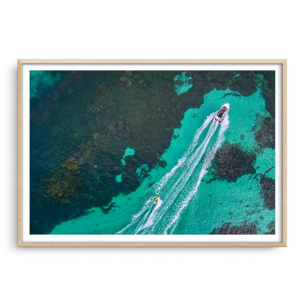 Aerial view of water skier in Augusta, Western Australia framed in raw oak