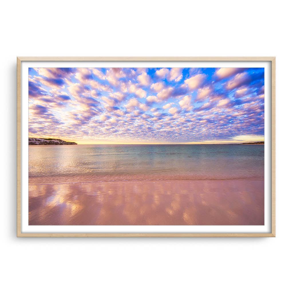 Cotton candy clouds over Sandy Cape in Western Australia framed in raw oak
