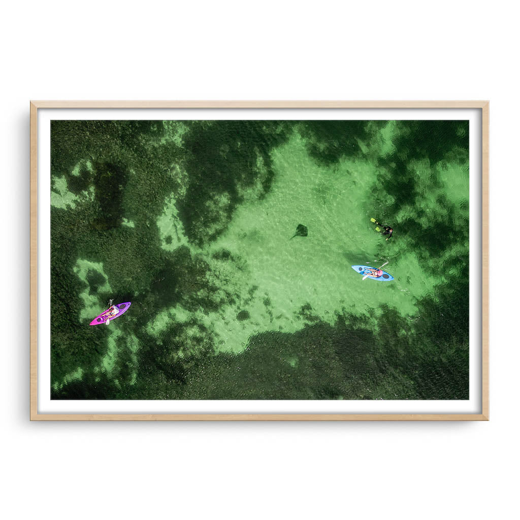 Aerial view of kayaks and stingray at Sandy Cape in Western Australia framed in raw oak