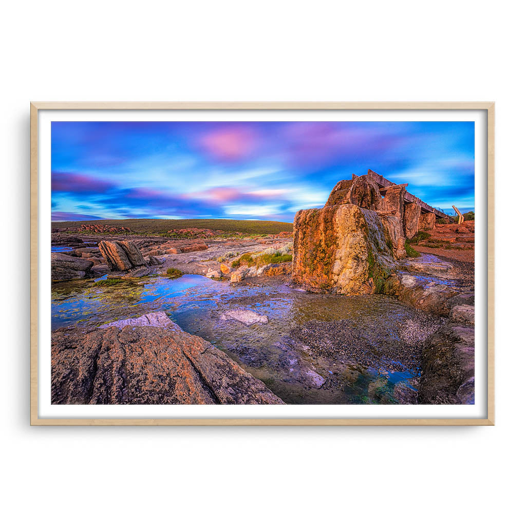 Old water wheel at sunset in Augusta, Western Australia framed in raw oak