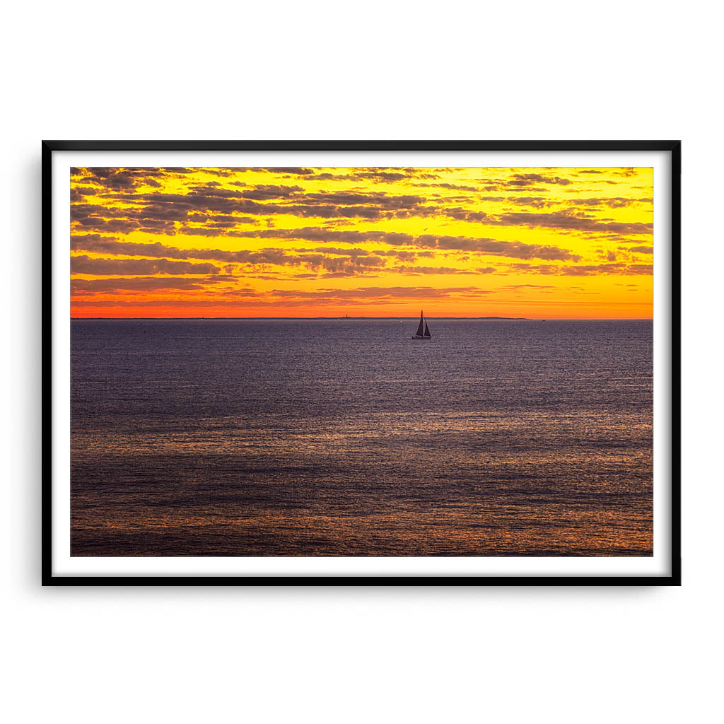 Boat sailing past rottnest island at sunset in Perth, Western Australia framed in black