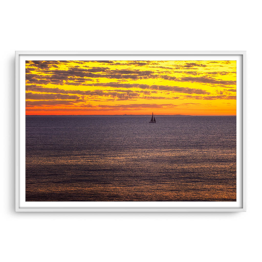 Boat sailing past rottnest island at sunset in Perth, Western Australia framed in white