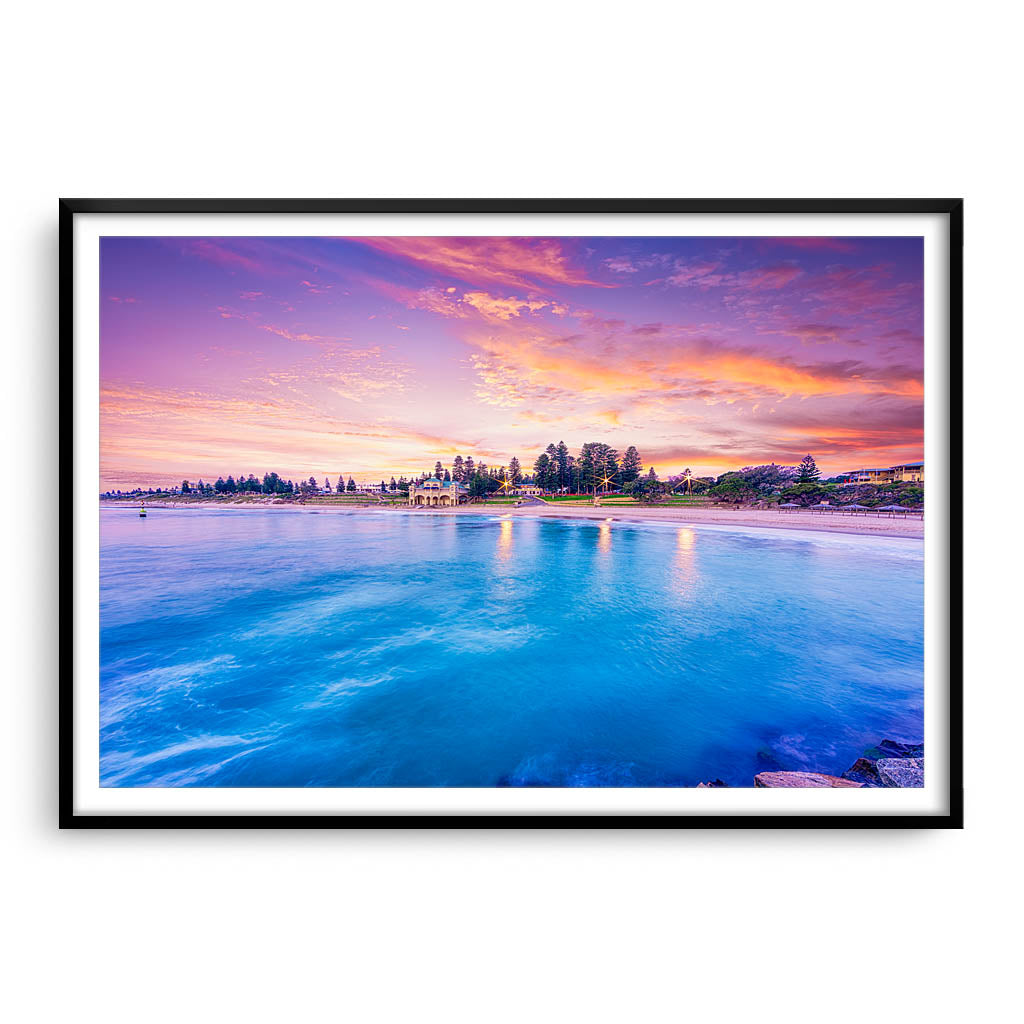 Blue waters and magenta skies over Cottesloe in Perth, Western Australia framed in black