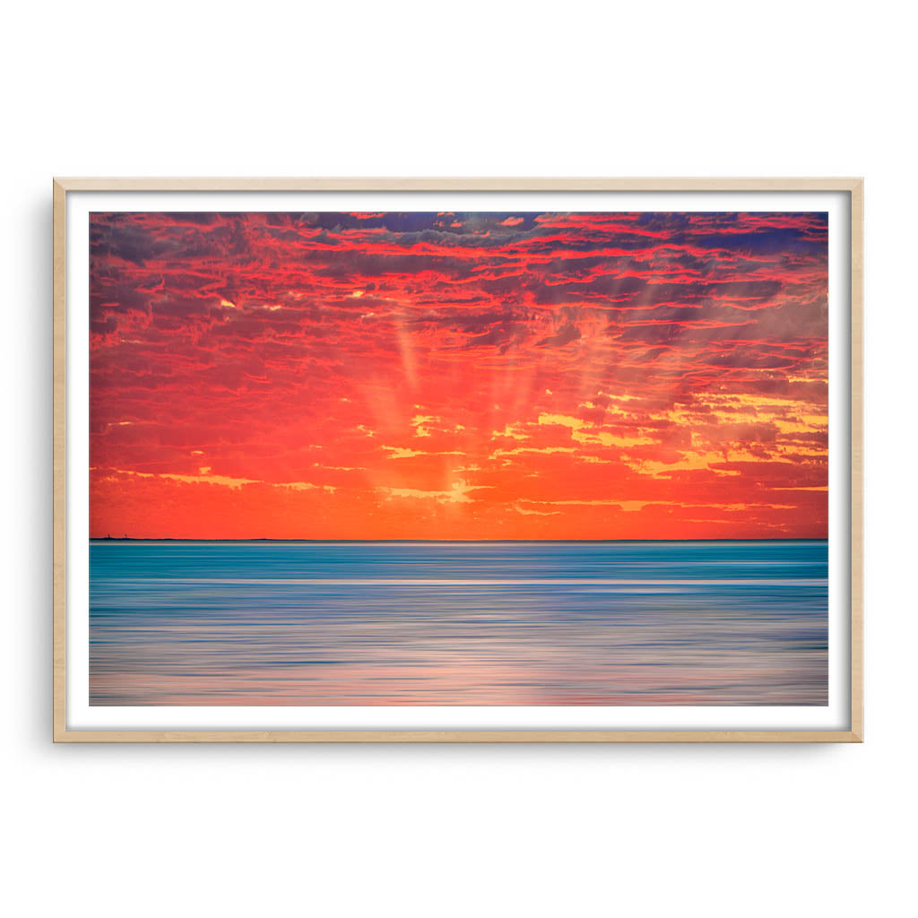 Sun rays over Scarborough Beach in Perth, Western Australia framed in raw oak