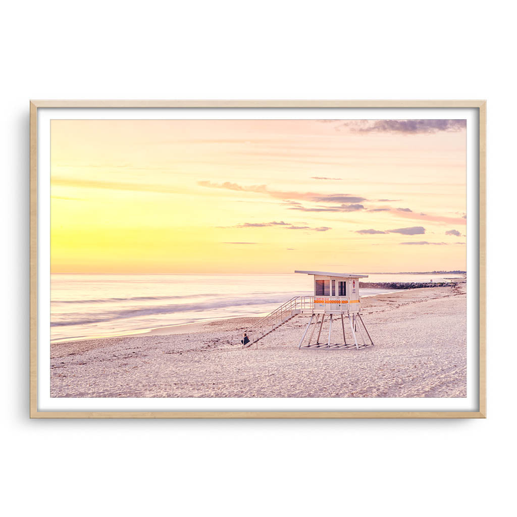 A calming sunset at City Beach in Perth, Western Australia framed in raw oak