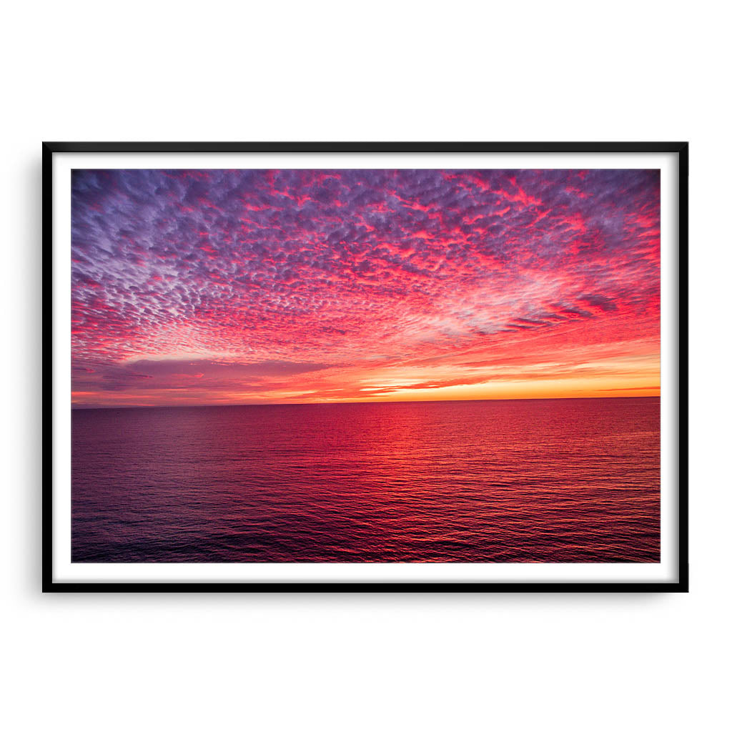 Sunset over the ocean at Mettams Pool in Perth, Western Australia framed in black