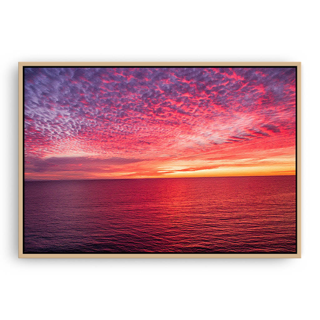 Sunset over the ocean at Mettams Pool in Perth, Western Australia framed canvas in raw oak