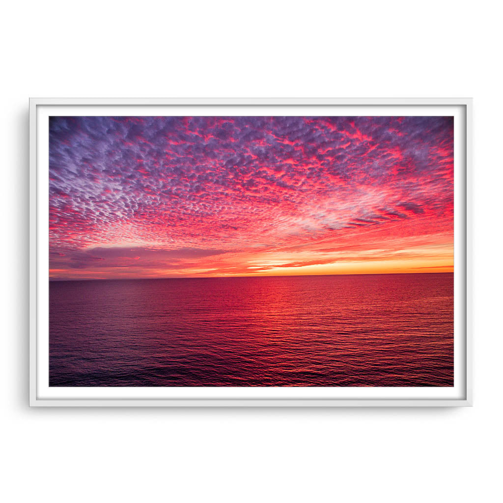 Sunset over the ocean at Mettams Pool in Perth, Western Australia framed in white