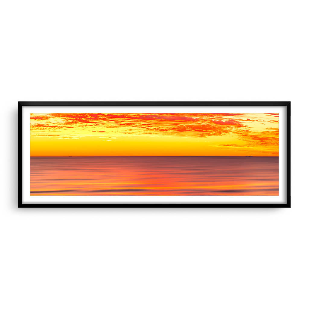 Golden skies over the ocean in Perth, Western Australia framed in black