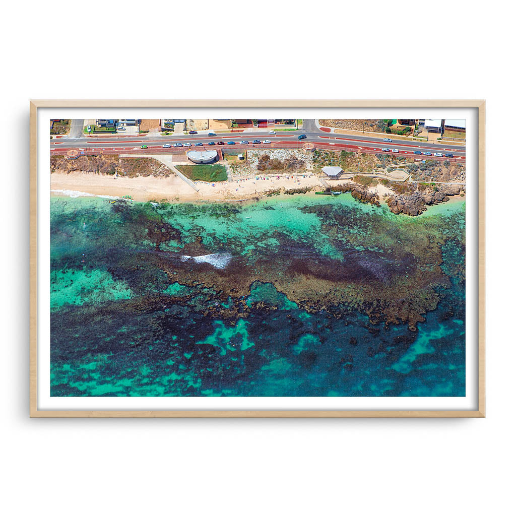 Aerial view of the reef at Mettams Pool in Perth, Western Australia framed in raw oak