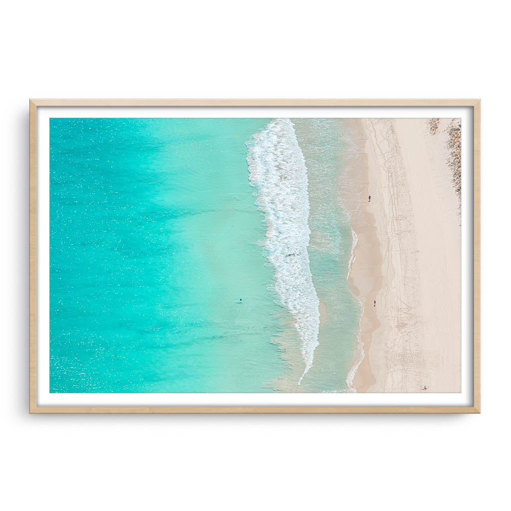 Aerial view of surfers at Trigg Beach in Perth, Western Australia framed in raw oak