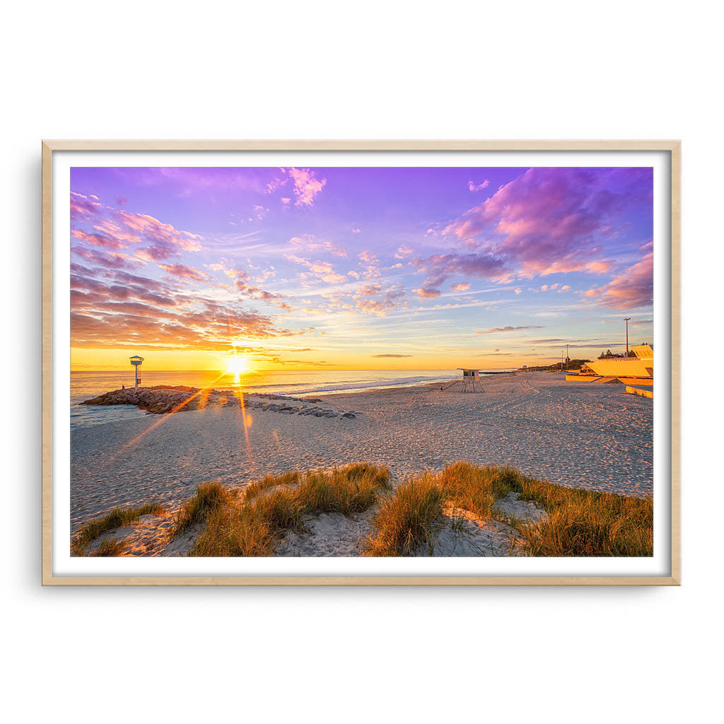 Winter sunset at City Beach in Perth, Western Australia framed in raw oak