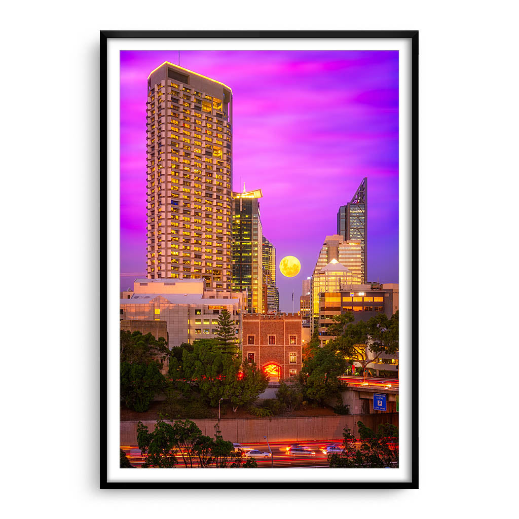 Moon rising through the city of Perth, Western Australia framed in black