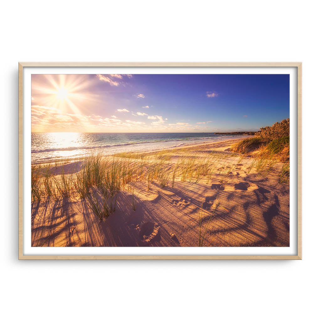 Sunset over the dunes of Sandy Cape in Western Australia framed in raw oak