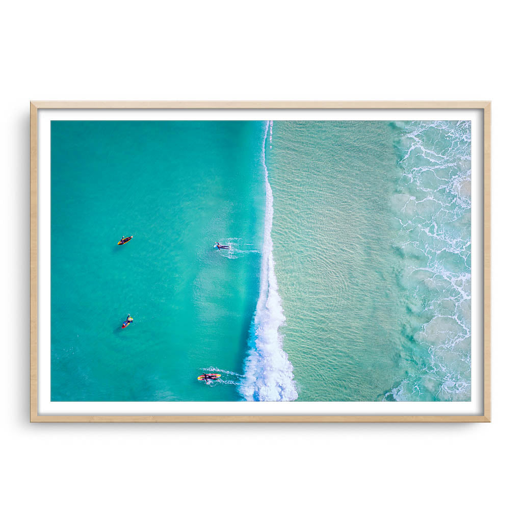 Aerial view of surfers at Trigg Beach in Perth, Western Australia framed in raw oak