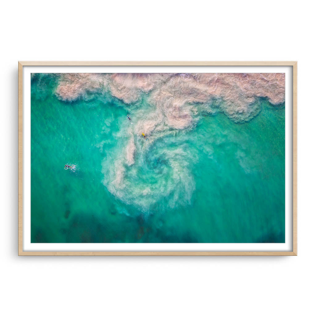 Aerial view of a rip at Mullaloo Beach in Perth, Western Australia framed in raw oak
