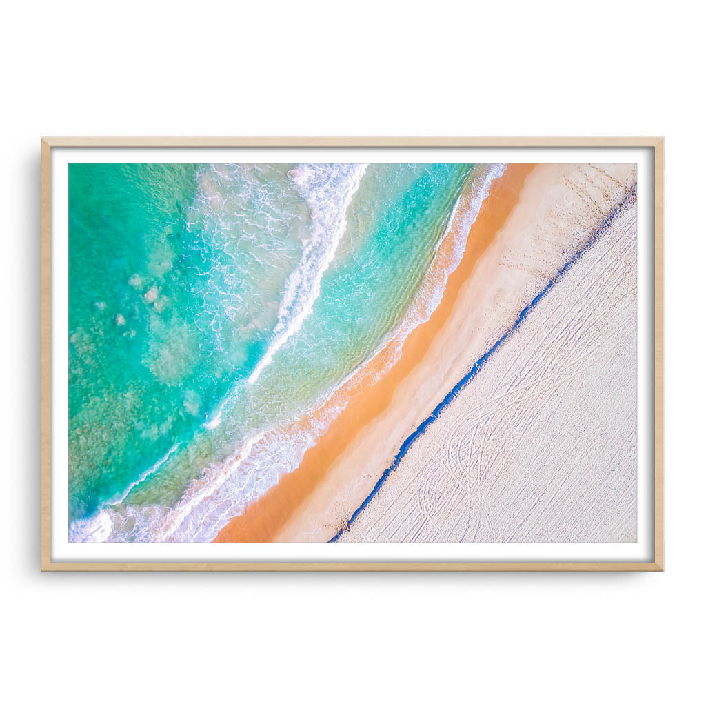 Aerial view of Trigg Beach in Perth, Western Australia framed in raw oak