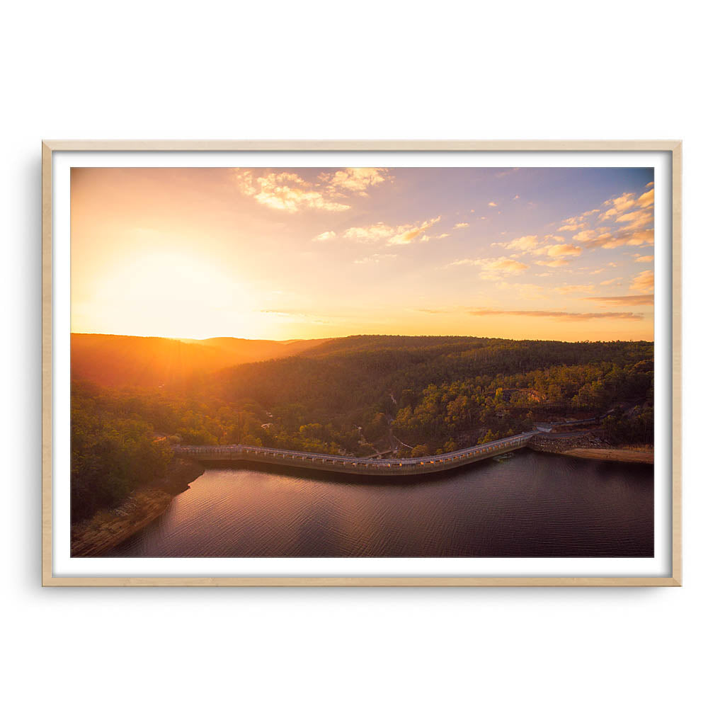 Sunset over Collie Dam in Western Australia framed in raw oak